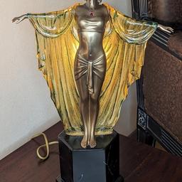Elegant lady art deco table lamp.                                       Bulb fitting behind the amber robe.                             With an on and off switch.                                        3 pin electric plug                                                    48 inches tall x 30 inches wide                                             Had for quite a few years.                                             In excellent condition with no damage collection S267XL