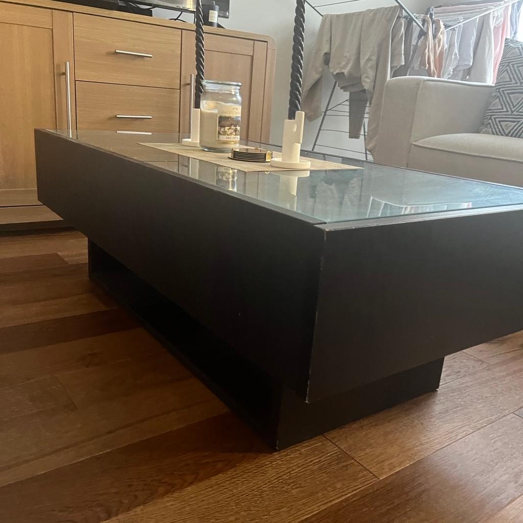Coffee table with Glass top and side draws. Underneath storage. Recently moved in and no longer fits our space