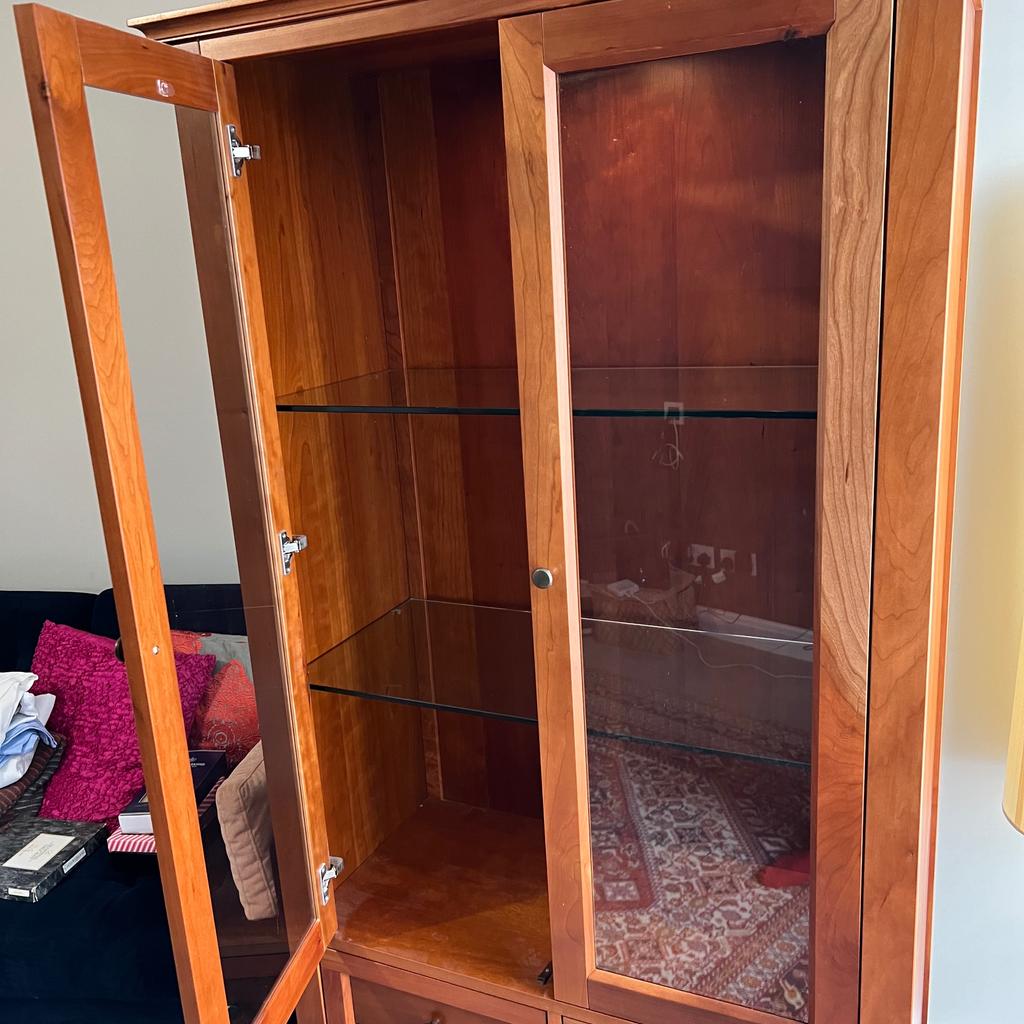 Beautiful and solid display cabinet. Cherry wood. Two glass doors and two glass shelves. Three drawers. Internal down-light to illuminate your glass-ware and china.

179cm tall, 90cm wide, and 43cm deep.

Brand: Stowe. Originally bought from John Lewis (for £1200).

Buyer must collect from Didsbury, South Manchester.