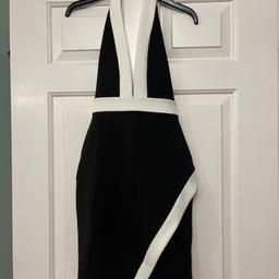 Brand new with tags still attached.
Black and cream halter neck, slashed to the waist; stretch bodycon dress with wrap over skirt, size 4 by Missguided.
