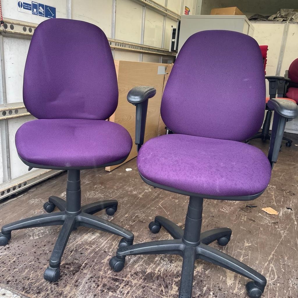 Two purple matching office chairs full working order extending . One has arms one doesn’t