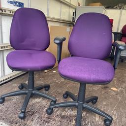 Two purple matching office chairs full working order extending . One has arms one doesn’t