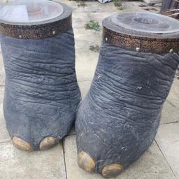 Pair of elephant feet which we believe are reproductions. They do have a fuzzy texture. One does have a slight tear when it has been moved. 
Can be used as side tables, storage or umberella stands. 
Any queries, please get in contact
