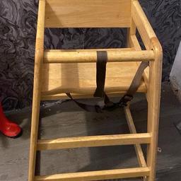 Wooden high chair with straps wiped down and ready to leave
