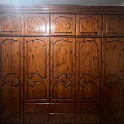 16 compartment wardrobe. Space for hanging and additional storage. Sold oak luxe dark brown wardrobe in great condition. Selling due to moving location. 5 hanging compartments and 11 pull out draws. Bought for £3500