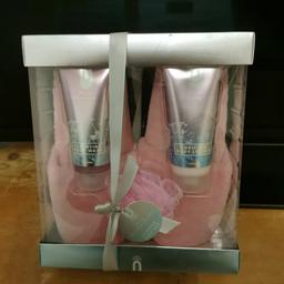 Brand new unopened gift set wild orchid cleaning body wash and body lotion pair of pink slippers and body wash puff unwanted gift