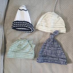 4 hats. the white one and the cream one by george. the blue and green one by Kyle and deena