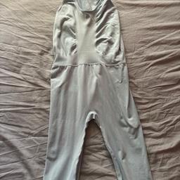 Sleeveless light blue work out jumpsuit. Never been worn still has tags attached. Material is recycled nylon.
