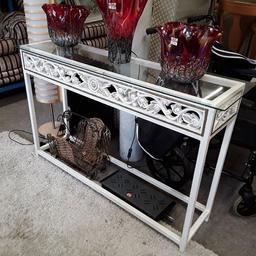 This lovely ornate white metal console table is in good used condition and has a removable glass top. There may be odd marks on the legs and very light surface scratches on the glass...

Table frame - 47.5 inches wide x 12 inches deep x 37 inches high.
With glass - 49 inches long x 14 inches deep x 37.5 inches high.

Our second hand furniture mill shop is LOW COST MOVES, at St Paul's trading estate, Copley Mill, off Huddersfield Road, Stalybridge SK15 3DN...Delivery available for an extra charge.

There are some large metal gates next to St Paul's church... Go through them, bear immediate left and we are at the bottom of the slope, up from the red steps... 

If you are interested in this or any other item, please contact me on 07734 330574, or on the shop 0161 879 9365...Many thanks, Helen.

We are OPEN Monday to Friday from 10 am - 5 pm and Saturday 10 am -  3.30 pm.. CLOSED Sundays. CLOSED Bank Holiday long weekends...