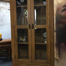 Solid oak rustic display cabinet in fabulous condition. A really heavy piece of quality furniture built to last. 2 x adjustable and one fixed shelf inside and a large drawer in the base. The unit measures 90cm wide x 36cm deep x 190cm tall. Viewing/collection is Leeds LS24 & delivery is available if required - £295