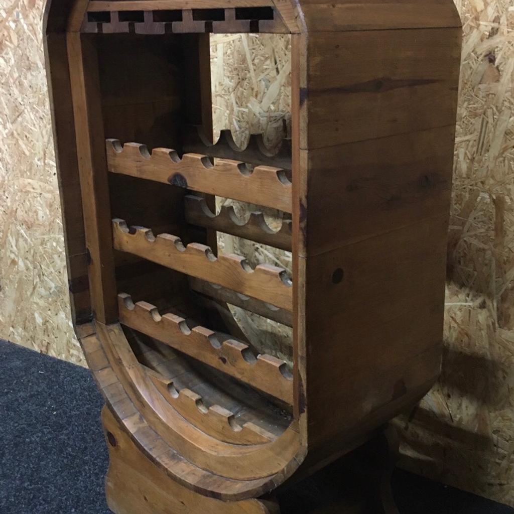Large solid wood barrel wine rack which holds 21 bottles of wine and also has space to hang 5 rows of wine glasses at the top. Ideal for a home pub:bar. The unit measures 68cm wide x 35cm deep x 121cm tall. Viewing/collection is Leeds LS24 & delivery is available if required - £150