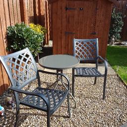 Grey metal chairs and glass top table as new never used outside