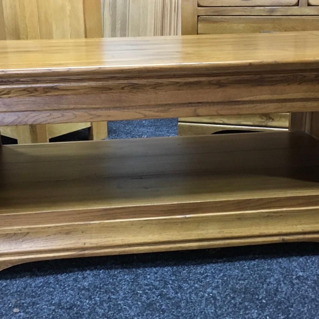 Large solid oak rustic coffee table. A really heavy piece of quality furniture with 2 x display shelves. The table measures 110cm long x 60cm wide x 47cm tall. Viewing/collection is Leeds LS24 & delivery is available if required - £165