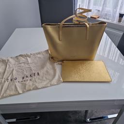 A nice Gold Ted Baker, has a few scratches on the front and back. Only notice them if you look closely.
Has a nice little clutch bag to match.
Also had a protector bag to keep it in.
£15 low price because of the couple of scratches on it.