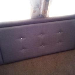 headboard. pale blue with crystal buttons. velcros to wall.