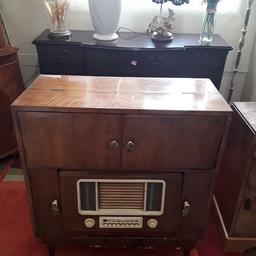 This fabulous early 1900's walnut veneered radiogram is a non-working item. I'm sure, in the right hands, someone could get this working again?!?

The model and serial number can be seen as well as it's authenticity label... Unsure of the make however.

Our second hand furniture mill shop is LOW COST MOVES, at St Paul's trading estate, Copley Mill, off Huddersfield Road, Stalybridge SK15 3DN...Delivery available for an extra charge.

There are some large metal gates next to St Paul's church... Go through them, bear immediate left and we are at the bottom of the slope, up from the red steps... 

If you are interested in this or any other item, please contact me on 07734 330574, or on the shop 0161 879 9365...Many thanks, Helen.

We are OPEN Monday to Friday from 10 am - 5 pm and Saturday 10 am -  3.30 pm.. CLOSED Sundays. CLOSED Bank Holiday long weekends...
