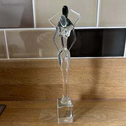 Lovely abstract sculpture depicting 2 people standing on a clear base.