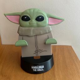 Star Wars  - PALADONE  products Limited
The Mandalorian  - the child
Baby Yoda 
Mobile phone stand 
iPhone stand / phone rest 
Phone  stand 
Excellent clean condition, it has never been used just sat in a drawer. 
Retail price was £10
Listed on multiple sites 
From a smoke free pet free home