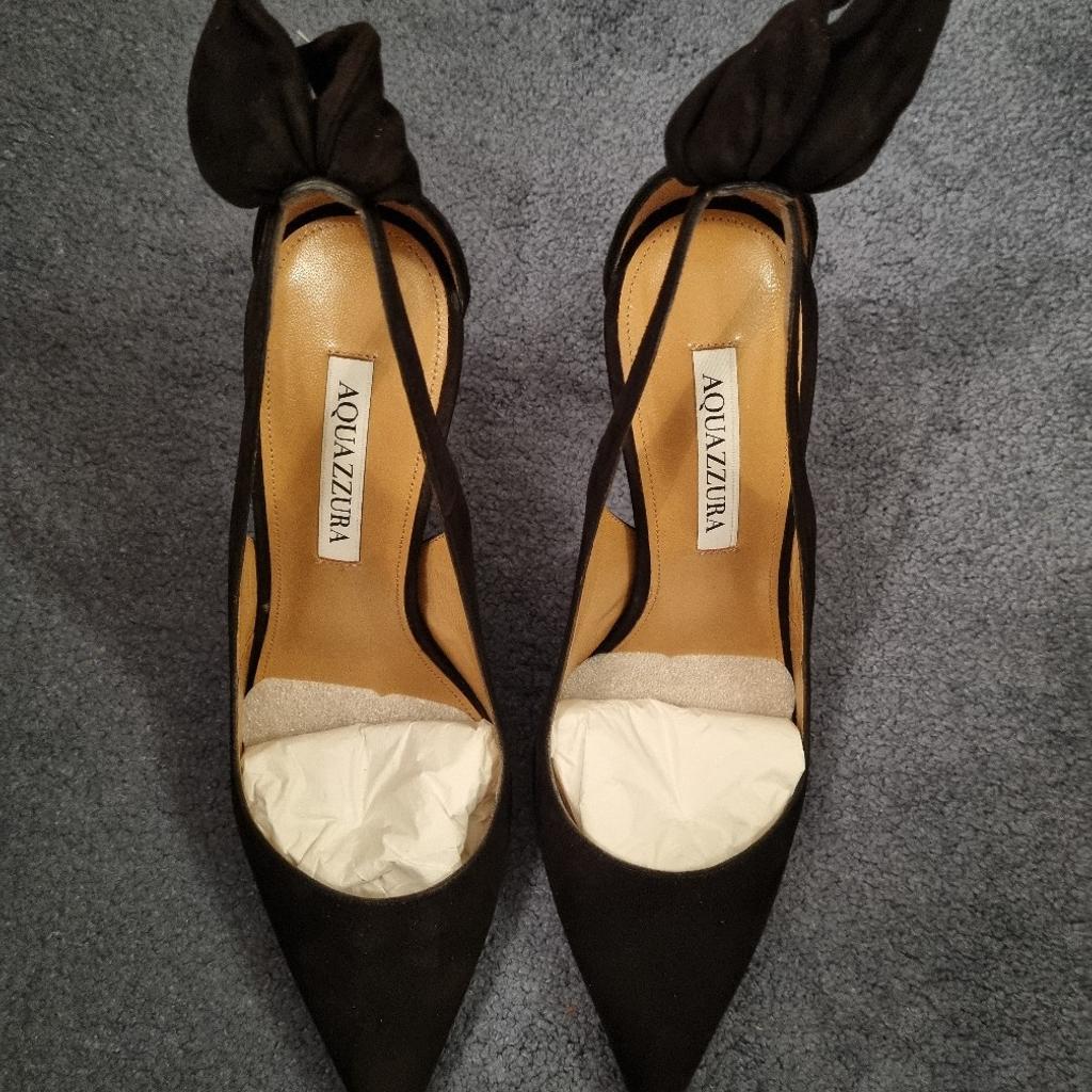 Elevate your shoe collection with these stunning Aquazzura Bow Tie Pumps. Crafted from luxurious black suede, these heels feature a delicate bow accent and trendy tie closure. Perfect for any formal occasion, these pumps will add a touch of elegance to your outfit. With a size of 6 (39), they are suitable for women who want to make a statement with their footwear.

These have only been worn once and are in perfect condition (apart from the worn soles as shown in the photo)