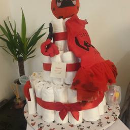 Baby Handmade Love Bug Nappy Cake 🎂
Perfect for gifting for New baby, Christenings, Baby showers, birthdays, Xmas etc 

Size: 0-3 months
Colour: Red

Contents:
• 40 Nappies (size 2)
• Outfit (hat, tutu vest & tights)
• Soft toy
• Wet wipes
• Lotion/Bubble bath
• Talc powder 

Condition: #New will be wrapped in cellophane with bow attached 

*Also available in:
• Red - baby santa 🎅 (unisex)
• Beige - Teddy (unisex)
• White or Navy
• Pink