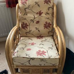 Custom-made wicker furniture, ideal for a conservatory. Beige cushioning with a beautiful floral pattern. Comes as a set with one armchair and a footstool.