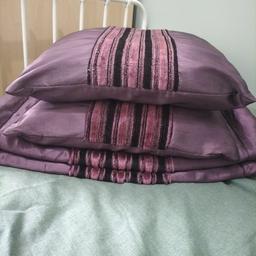 Purple bedding and pillow case covers.