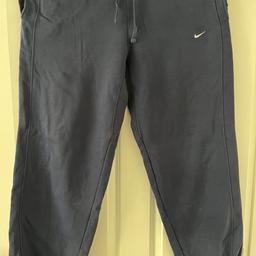 Navy Nike tracksuit bottoms. Slight colour fading due to age but otherwise in good condition.