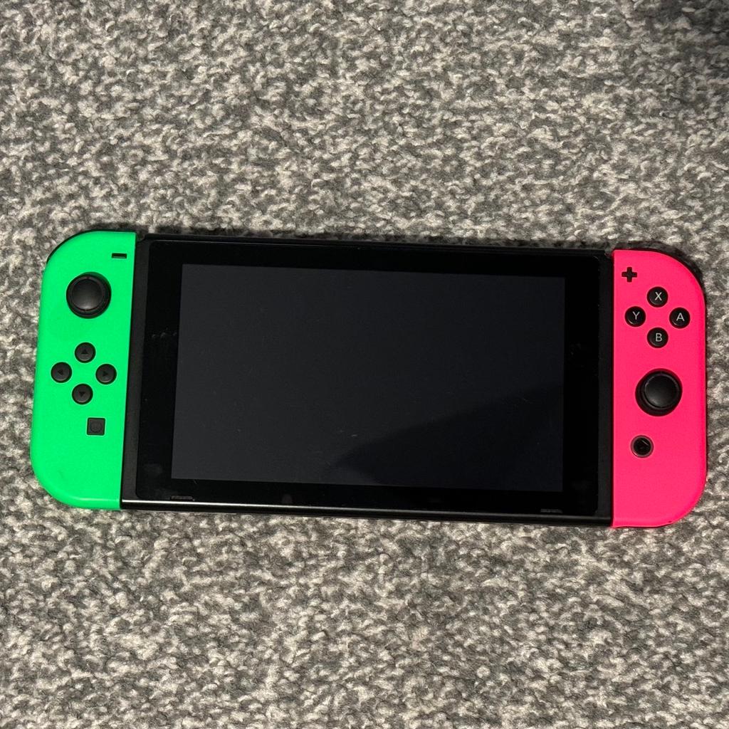 Nintendo Switch with neon green/pink controllers. Comes with box and all accessories included when bough brand new. Console and controllers work perfectly. Nintendo screen itself has markings on from taking it in and out of docking station. Also includes six games: Platoon 2, Super Mario Odyssey, Crash bandicoot, Lego Ninjago, Mariokart 8 Deluxe and 1, 2 Switch.