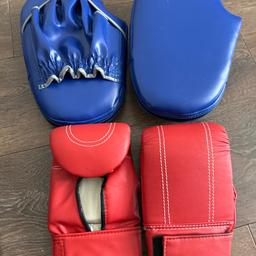Sparring gloves and pads.
Left and right hand targets in blue. 
Pair of red sparring gloves.
Synthetic, wipe able material.
New with tags in mesh bag for easy storage.