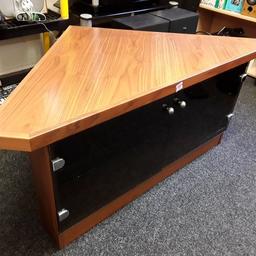 This lovely heavy duty oak veneered corner TV stand has two black glass doors on the front. Good all-round condition although some of the veneer is a bit damaged on some of the edges...

50 inches long x 28.5 inches deep x 21.5 inches high.

Our second hand furniture mill shop is LOW COST MOVES, at St Paul's trading estate, Copley Mill, off Huddersfield Road, Stalybridge SK15 3DN...Delivery available for an extra charge.

There are some large metal gates next to St Paul's church... Go through them, bear immediate left and we are at the bottom of the slope, up from the red steps... 

If you are interested in this or any other item, please contact me on 07734 330574, or on the shop 0161 879 9365...Many thanks, Helen.

We are OPEN Monday to Friday from 10 am - 5 pm and Saturday 10 am -  3.30 pm.. CLOSED Sundays. CLOSED Bank Holiday long weekends...