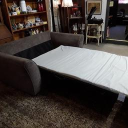 This brown fabric sprung base two-seater modern bed settee is in good all-round used condition. Some general wear to the fabric in places but good overall. The mattress is in excellent unused condition... It is quite thin however.

The sofa itself is 71 inches wide arm to arm x 38 inches deep x 33 inches high.
The sofa bed section is 46.5 inches wide x 6 ft long x 16.5 inches high.

Our second hand furniture mill shop is LOW COST MOVES, at St Paul's trading estate, Copley Mill, off Huddersfield Road, Stalybridge SK15 3DN...Delivery available for an extra charge.

There are some large metal gates next to St Paul's church... Go through them, bear immediate left and we are at the bottom of the slope, up from the red steps... 

If you are interested in this or any other item, please contact me on 07734 330574, or on the shop 0161 879 9365...Many thanks, Helen.

We are normally OPEN Monday to Friday from 10 am - 5 pm and Saturday 10 am -  3.30 pm.. CLOSED Sundays. CLOSED Bank Holidays.