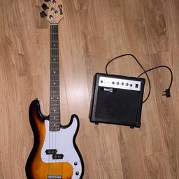 A basic Rock Jam bass guitar, with a volume and bridge pickup knobs. Sunburst colour, 20 frets, no strap included, no new strings included.

Basic Rock Jam GA-20W amp with master volume, treble, middle, bass knobs and a headphone jack.