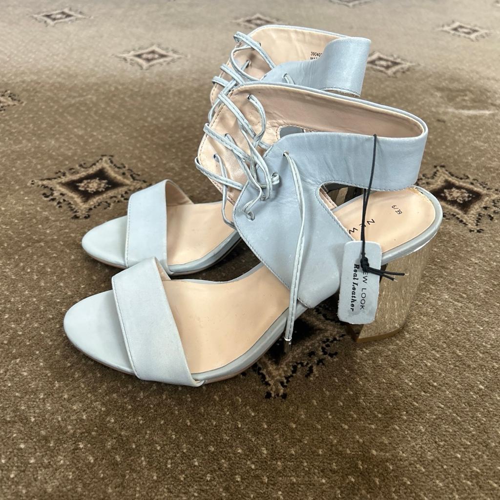 Elevate your style this summer with these stunning blue strappy sandals from New Look. Crafted from real leather, these sandals are perfect for any occasion. The open toe design and block heels make them comfortable and stylish at the same time.

These brand new sandals come in size 6 and are perfect for women who want to add a touch of sophistication to their outfit. The strappy design and blue colour give them a unique look that will make you stand out from the crowd. Whether you're heading to a party or a casual day out, these sandals are a must-have addition to your wardrobe.