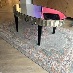 glass coffee table with dark wood legs with cur glass edging