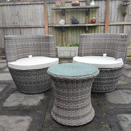 Ratten wicker bistro set in grey colour. Glass top table with 2 chairs and seat cushions. Stacks on top of each other for easy storage. Table: 42cm x 48cm, Chair: 66cm x 66cm x 37cm. Never been used so in great condition