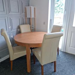 Extendable table and 4 cream leather chairs, leather on chairs starting to peel, nothing some chair covers wouldn't make look new! very heavy and sturdy table and chairs