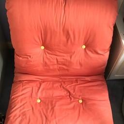 Single futon chair /bed. Wooden frame which is very good condition. Cushion is orange/rust colour on one side and yellow on the other. 
Cash on collection only.