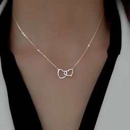 This elegant double heart necklace is the perfect addition to any woman's jewellery collection. The stylish chain is suitable for any occasion, whether it's a formal evening event or a casual day out.

Crafted with care, this necklace is of superior quality, ensuring that it will last for years to come. The double heart design is timeless and adds a touch of romance to any outfit. Don't miss out on the opportunity to own this beautiful piece of jewellery.