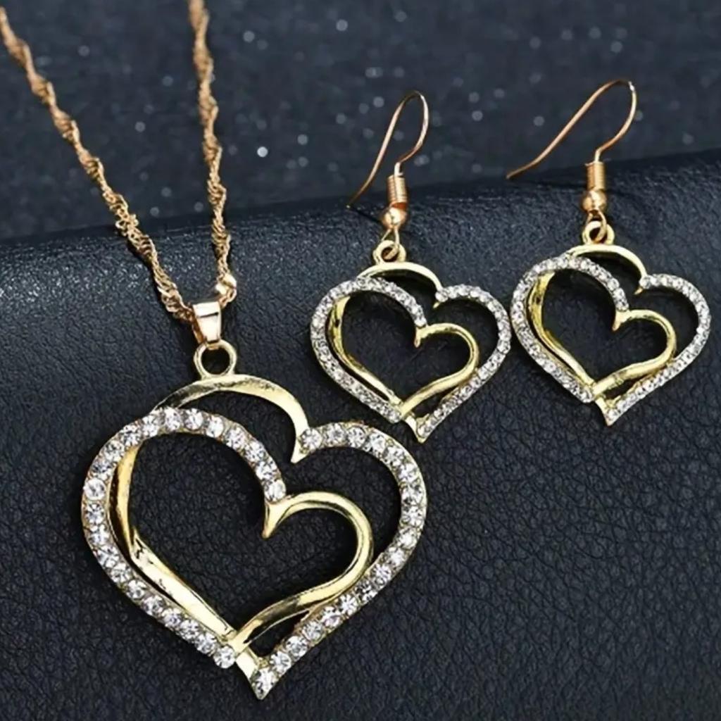 This stunning jewellery set is perfect for adding a touch of glamour to any outfit. Featuring three pieces, it includes a necklace and a pair of drop earrings, each adorned with exquisite heart-shaped cubic zirconia stones.

Crafted to the highest standard, this set is perfect for any occasion and adds a touch of elegance to any ensemble. Whether you're dressing up for a special event or simply adding some sparkle to your everyday look, this jewellery set is sure to turn heads
