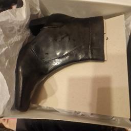 Black pair of patent boots. Brand new in the box and size 6. Collection Preferred or delivery available.