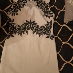 White and black dress by Lipsy with black petal patterns on the front of the dress. Only worn once and in great condition. Collection Preferred but can be posted.