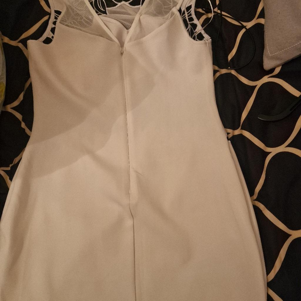 White and black dress by Lipsy with black petal patterns on the front of the dress. Only worn once and in great condition. Collection Preferred but can be posted.