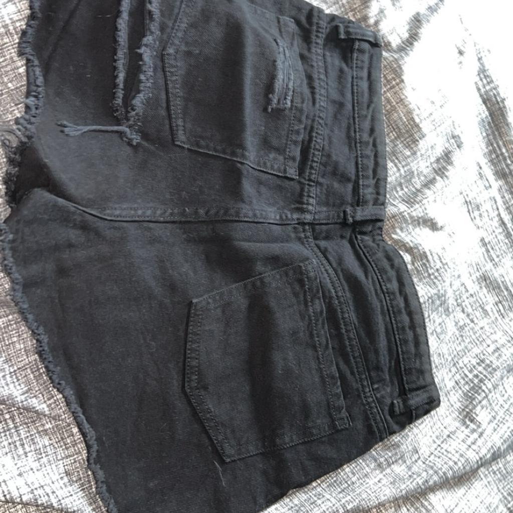 Worn once. Black denim ripped shorts. Rip is on the backside of the shorts.