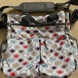 Baby changing bag with lots of pockets inside and outside. Also has 2 magnetic pockets on the front and a bottle holder on each side.