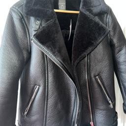 Black ladies biker jacket/ faux leather with faux fur inside and around collar. 
The size is 2xs but is roomy & can fit a size 10
