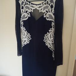 Beautifully fitting mini cocktail dress for a party or an evening work event. From LIPSY LONDON (love michelle keegan). Size UK12 fits 10 too. Long sleeves and cleavage in mesh fabric. Stunning white embroidery at the front.