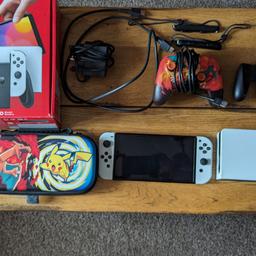 Nintendo Switch Oled bundle. Barley used in great condition. Will be factory reset when sent. Comes with a Pokémon switch case and Pokémon Charizard wired controller. All wires, cable's and accessories come with the Switch and box.