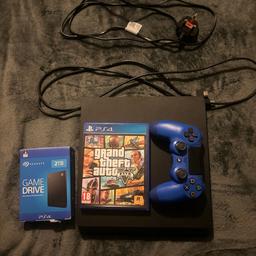 Black PS4 slim in great condition
Comes with 2TB external game drive so you can add up to 50+ games extra (worth £70!)
Also comes with blue controller rather than plain black
GTA V on disc included 
Wires are in perfect condition with no signs of breakage (power lead and HDMI)