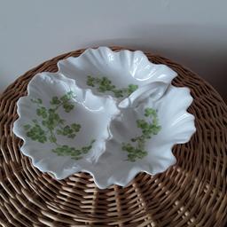 White porcelain dish divided into 3 for nuts , olives and party food etc. Dainty clover pattern in green. Small handle. Please see pictures. Perfect condition.