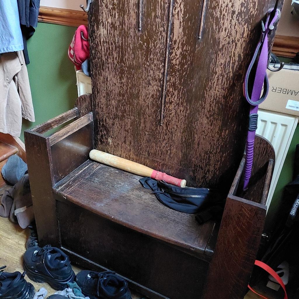 several hooks, mirror and storage in the bench
